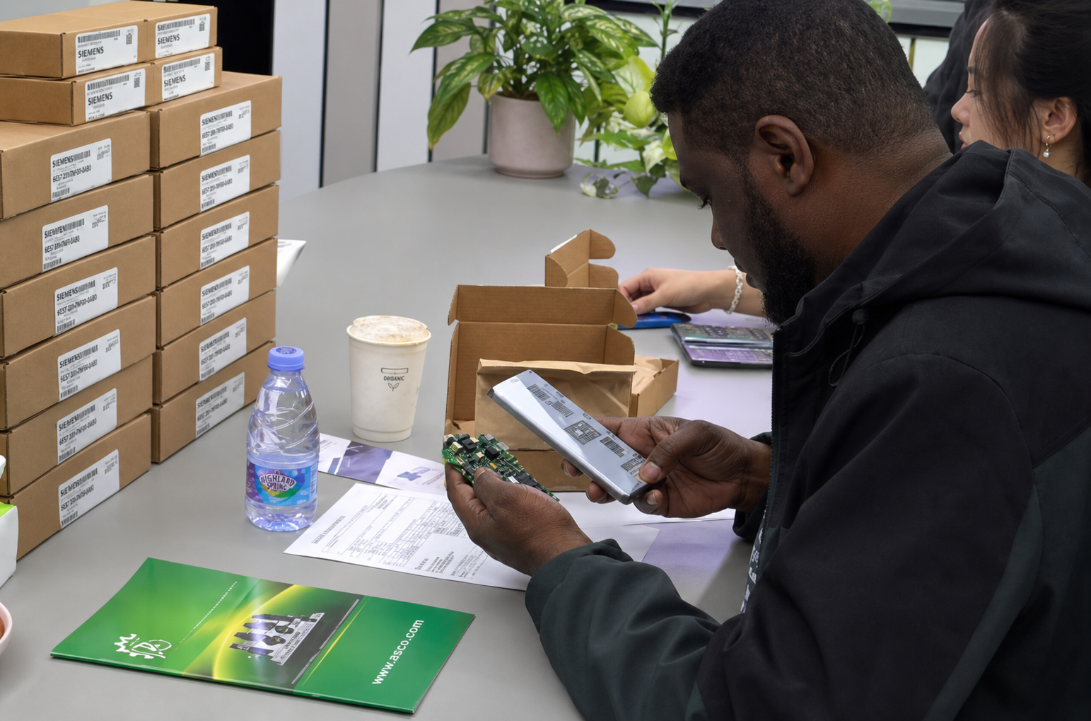 Customer inspecting industrial automation components and documentation
