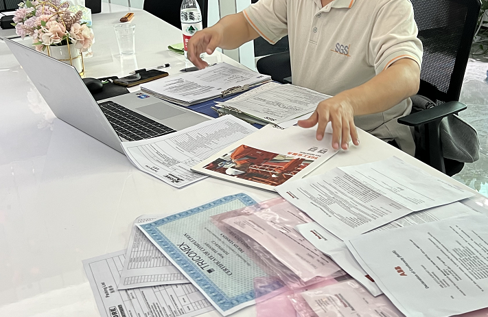 SGS inspector reviewing Moore Automated documents during a third-party on-site inspection